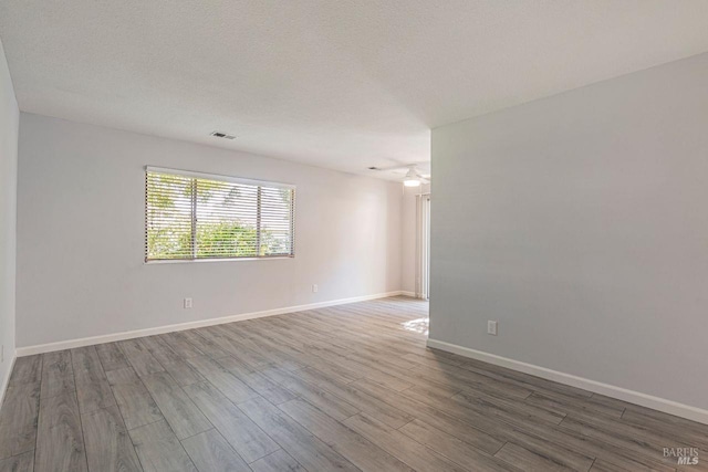 empty room featuring hardwood / wood-style floors and a textured ceiling