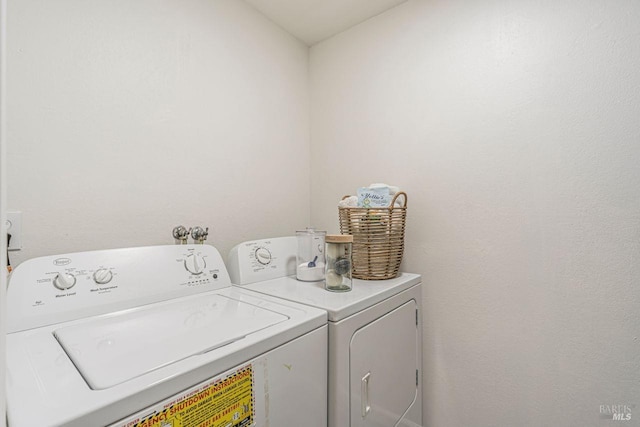 clothes washing area featuring washer and clothes dryer