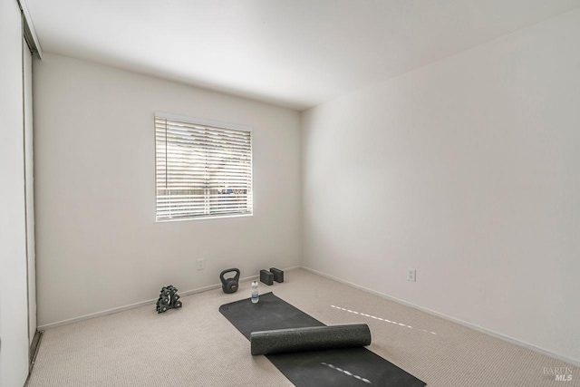 workout room with light colored carpet