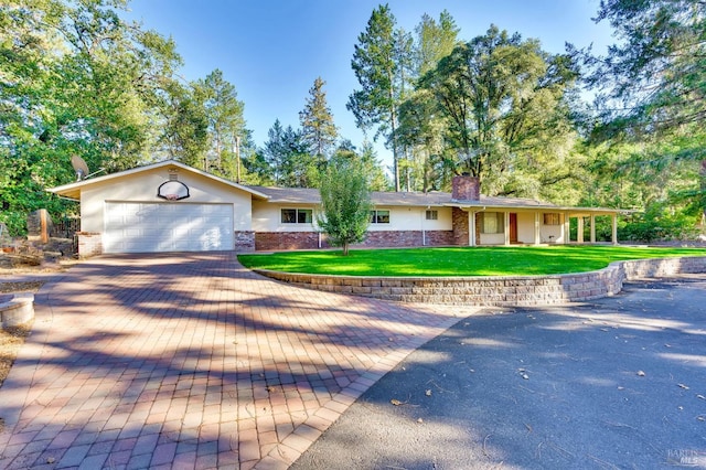 single story home with a front yard and a garage