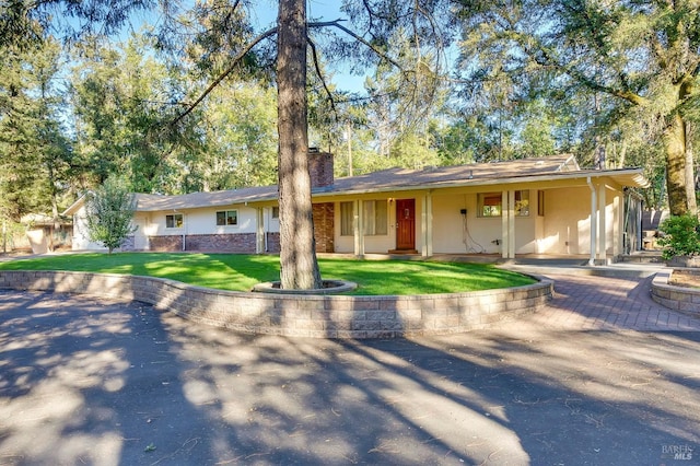 ranch-style home with a front lawn