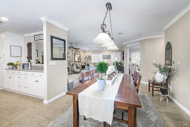 tiled dining room featuring ceiling fan and crown molding