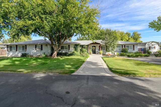 ranch-style house with a front lawn