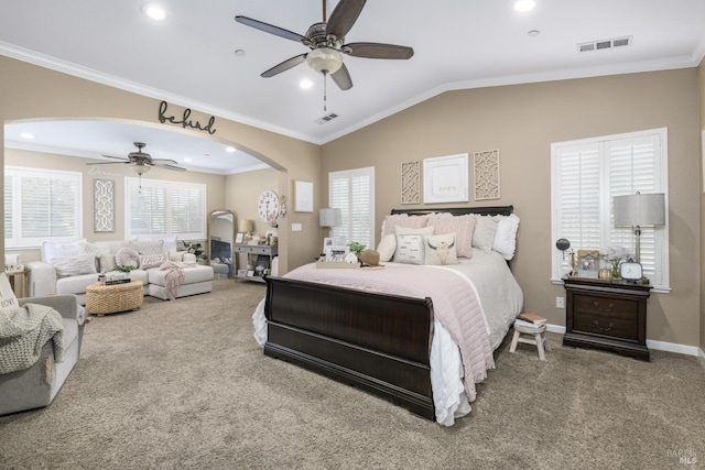 bedroom featuring visible vents, arched walkways, and carpet flooring
