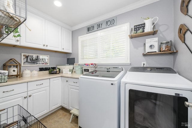 laundry area with cabinets, light tile patterned floors, ornamental molding, and independent washer and dryer