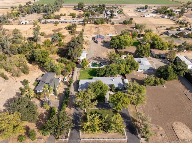 birds eye view of property with a rural view