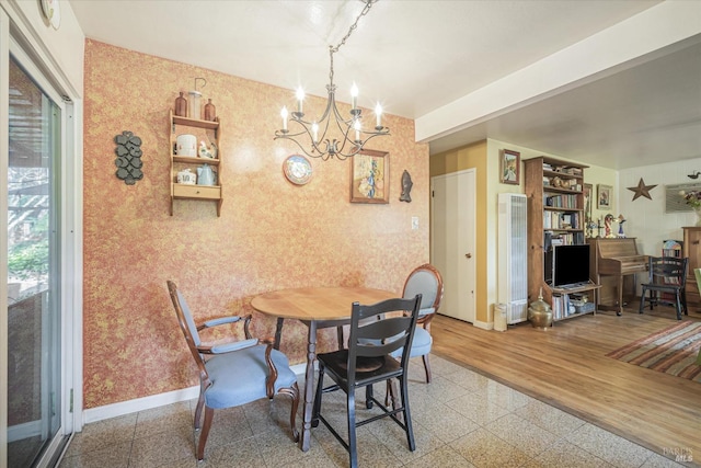 dining room featuring hardwood / wood-style floors and an inviting chandelier