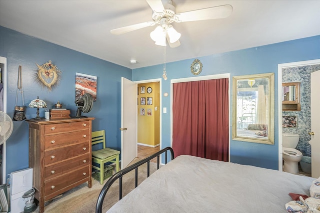 bedroom with connected bathroom, ceiling fan, and carpet flooring