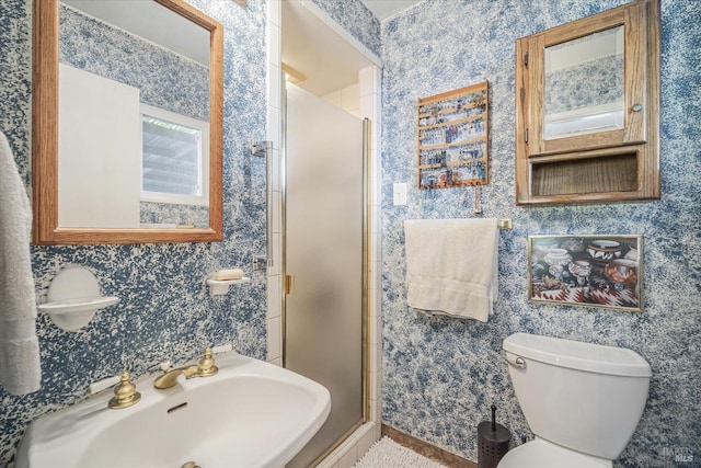 bathroom with toilet, sink, and an enclosed shower