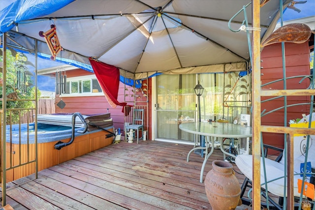 wooden deck with a gazebo and a covered hot tub