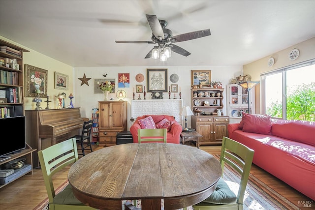 living room featuring hardwood / wood-style floors and ceiling fan