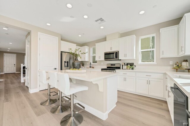 bathroom with tile patterned floors, plenty of natural light, vanity, and plus walk in shower