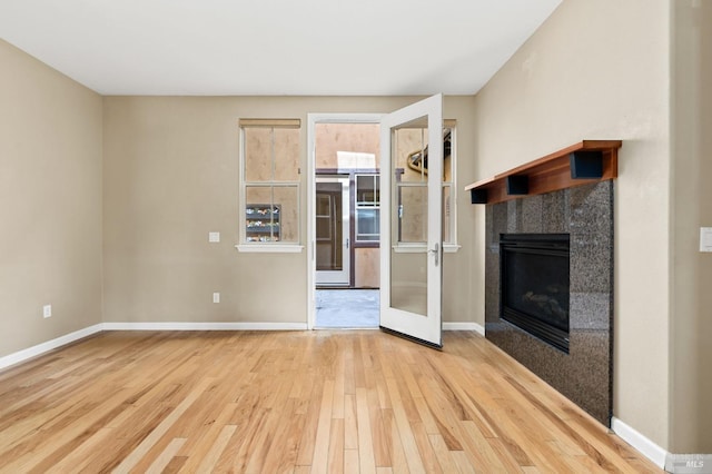 unfurnished living room with light hardwood / wood-style flooring and a fireplace