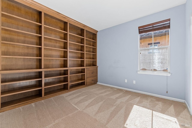unfurnished room with baseboards and carpet flooring