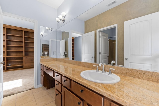 full bathroom featuring tile patterned floors, visible vents, a shower with shower door, and vanity