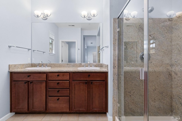 bathroom featuring vanity, tile patterned floors, and walk in shower