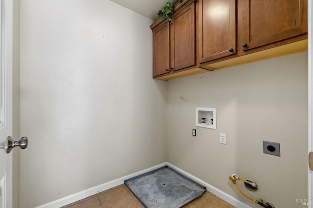 washroom with electric dryer hookup, hookup for a washing machine, gas dryer hookup, light tile patterned floors, and cabinets