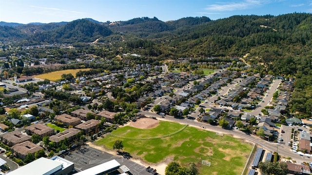 aerial view featuring a residential view, a mountain view, and a wooded view
