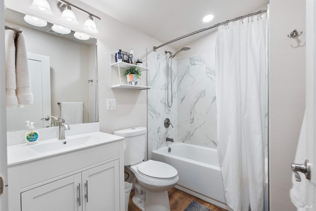 full bath with wood finished floors, vanity, toilet, and shower / bath combo with shower curtain