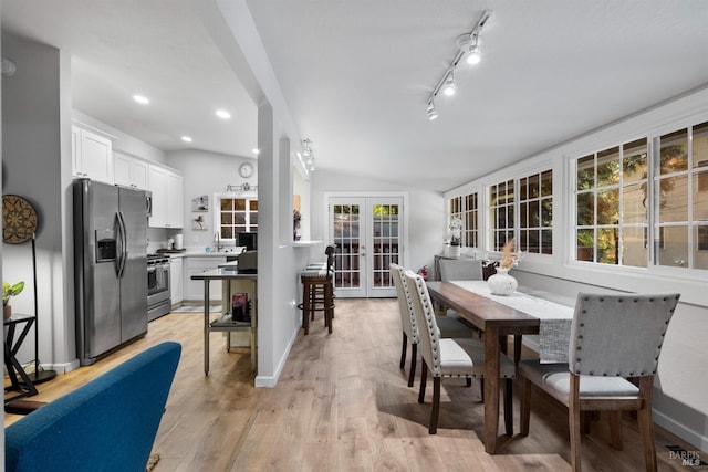 dining room with light wood-style flooring, recessed lighting, baseboards, vaulted ceiling, and french doors