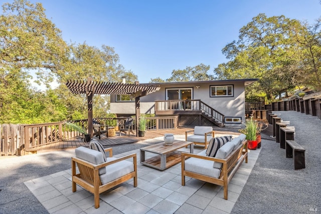 view of patio featuring a pergola, a wooden deck, and an outdoor living space