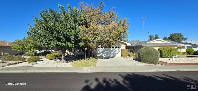 obstructed view of property with a garage