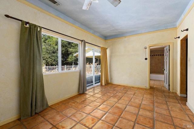 empty room with crown molding, light tile patterned floors, and ceiling fan