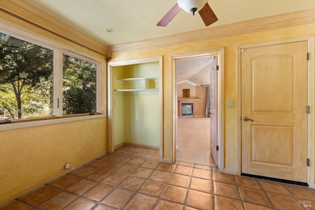 unfurnished bedroom with a closet, ceiling fan, and a textured ceiling