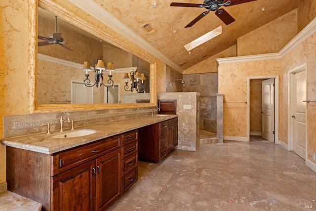 bathroom featuring ceiling fan, a shower, vaulted ceiling with skylight, crown molding, and vanity