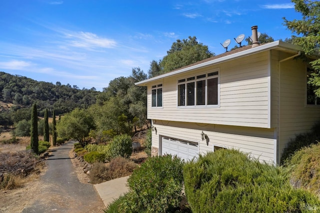 view of side of home featuring a garage