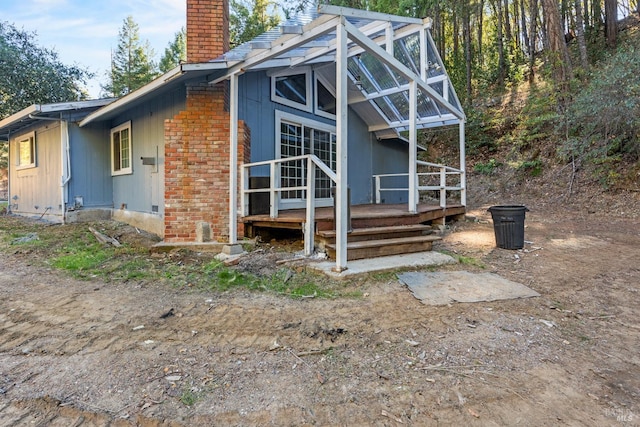 back of property featuring glass enclosure