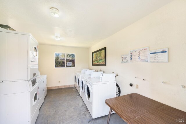 laundry room featuring stacked washer / drying machine, washing machine and dryer, and light carpet