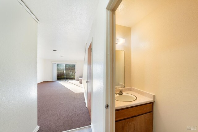 bathroom with vanity and a textured ceiling