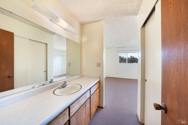 bathroom with vanity and a textured ceiling