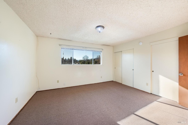 unfurnished bedroom with carpet floors and a textured ceiling