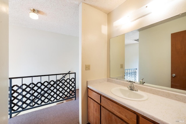 bathroom featuring vanity and a textured ceiling