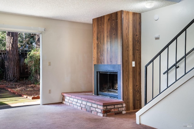 unfurnished living room featuring carpet and a textured ceiling