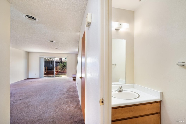 bathroom featuring vanity and a textured ceiling