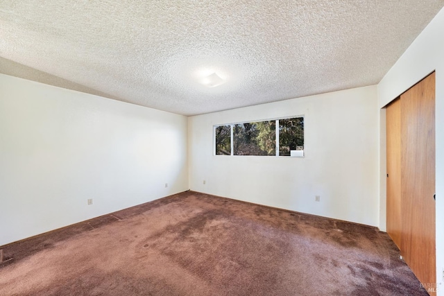 unfurnished bedroom featuring a closet, carpet, and a textured ceiling