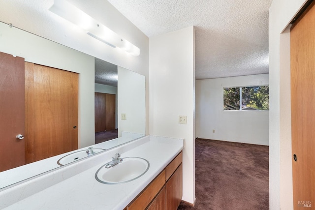 bathroom featuring vanity and a textured ceiling