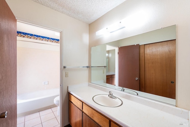 bathroom featuring vanity, tile patterned floors, a textured ceiling, and toilet