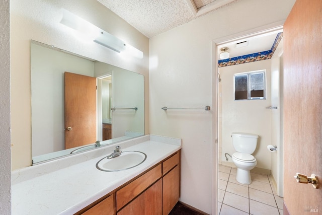 bathroom featuring tile patterned flooring, vanity, toilet, and a textured ceiling