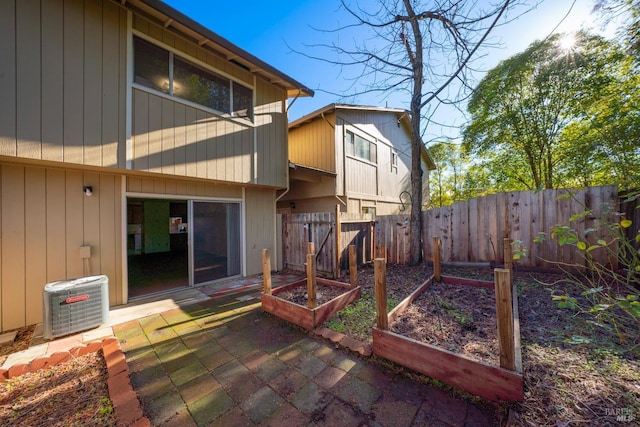 rear view of house featuring cooling unit