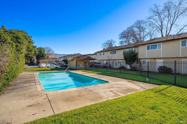 view of pool featuring a yard and a patio