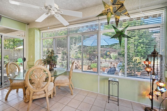 sunroom featuring ceiling fan