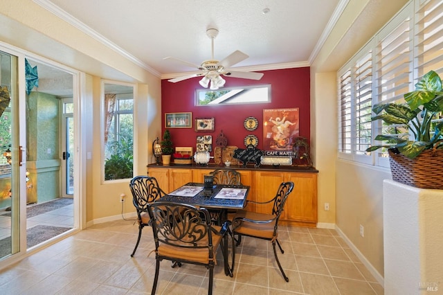 dining room with light tile patterned floors, plenty of natural light, crown molding, and ceiling fan