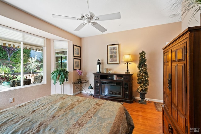 bedroom with ceiling fan and light hardwood / wood-style floors