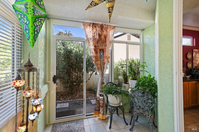 entryway with tile patterned flooring, plenty of natural light, and a textured ceiling