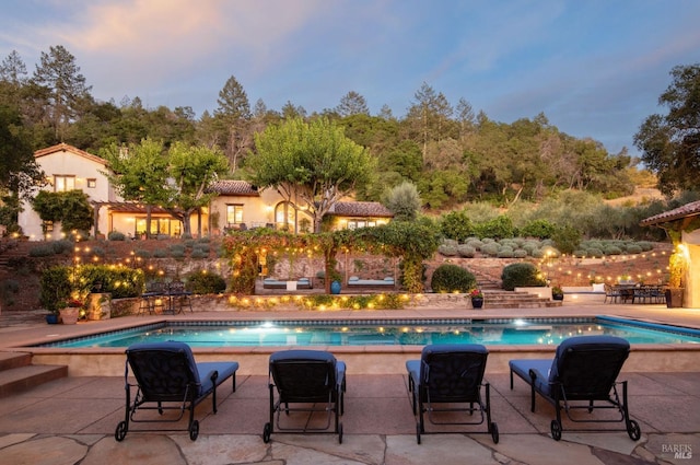 outdoor pool featuring a patio