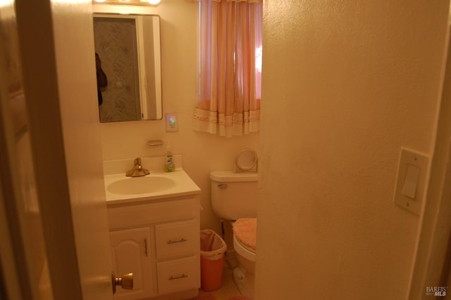 bathroom with vanity and toilet